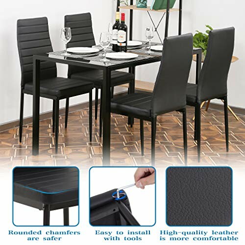 Black dining table set with four chairs, wine bottle, and glasses.