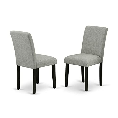 Two gray fabric dining chairs with black legs