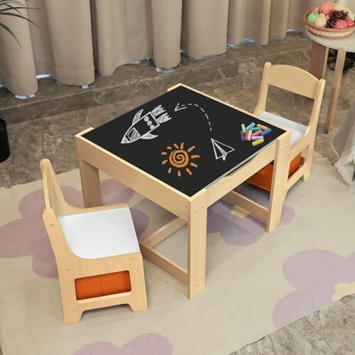 Children's play table with chalkboard surface and two chairs.