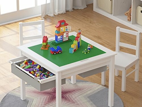 Children's play table with Lego blocks and chairs.