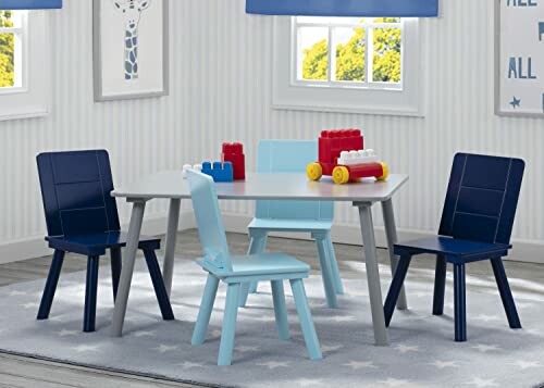 Children's playroom with table, chairs, and toy blocks.