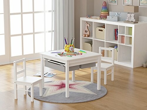 Children's playroom with a white table, chairs, and toys.