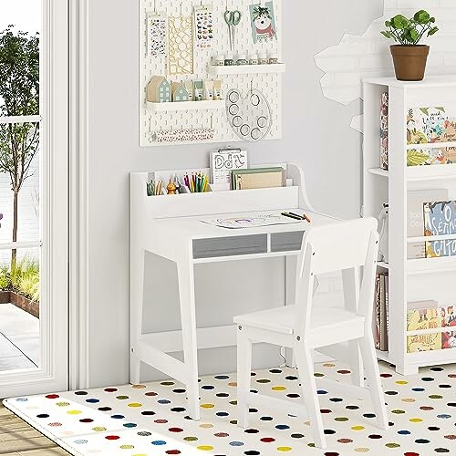 White kids desk and chair with colorful rug and wall decor.