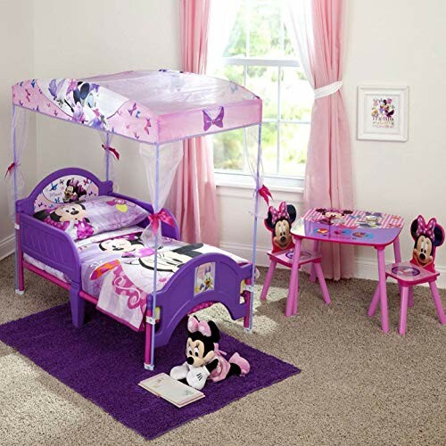 Minnie Mouse themed kids bedroom with bed, table, and chairs.