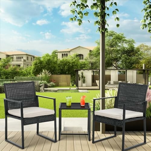 Outdoor patio with two chairs and a table in a garden setting.