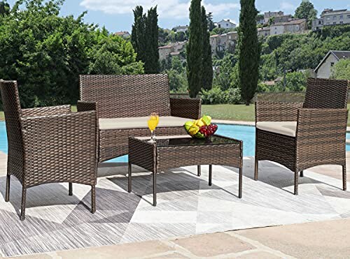 Outdoor wicker furniture set by a pool with trees and buildings in the background.