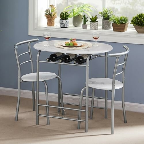 Small dining set with plants and wine glasses