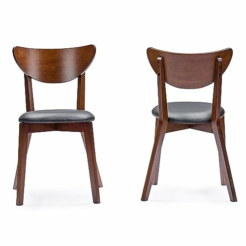 Front and back view of two wooden dining chairs with black cushions.